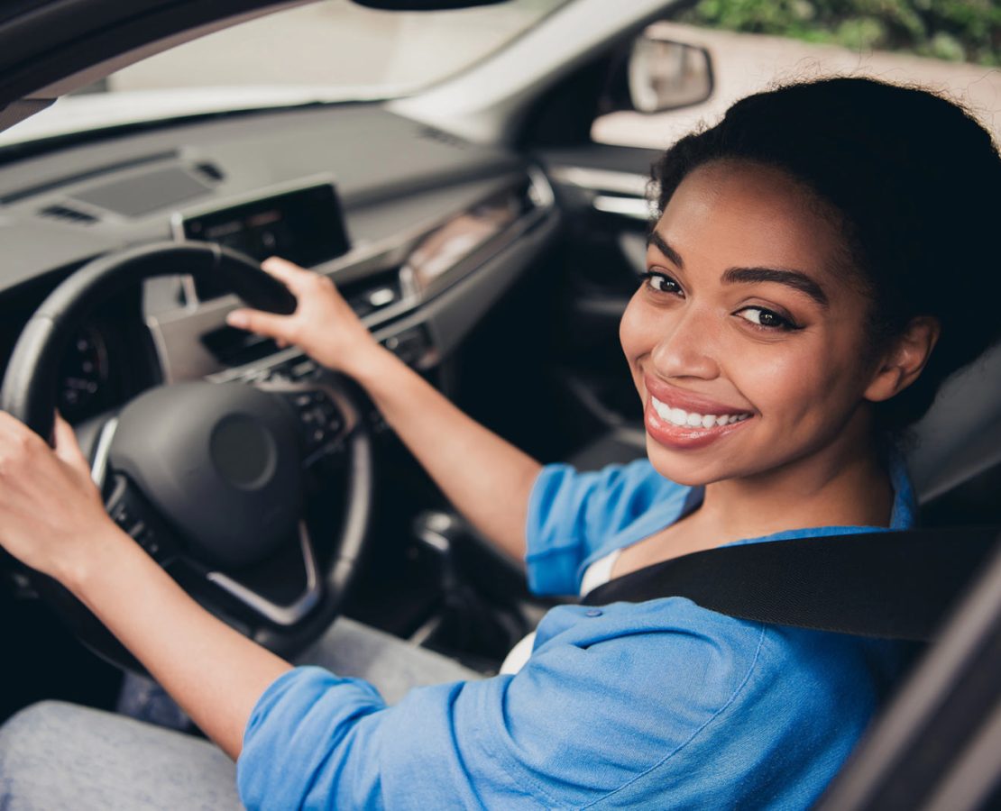 Woman in car with auto insurance in Alliance, OH