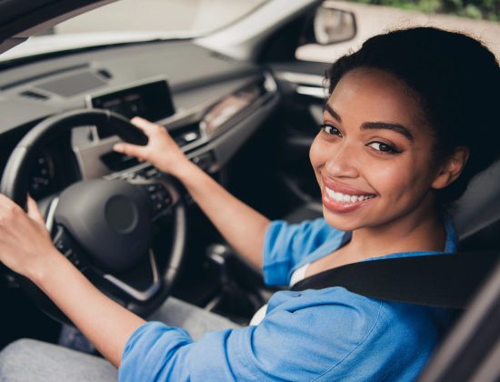 Woman in car with auto insurance in Alliance, OH