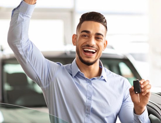 Man happy because he got a new car with affordable auto insurance in Austintown, OH